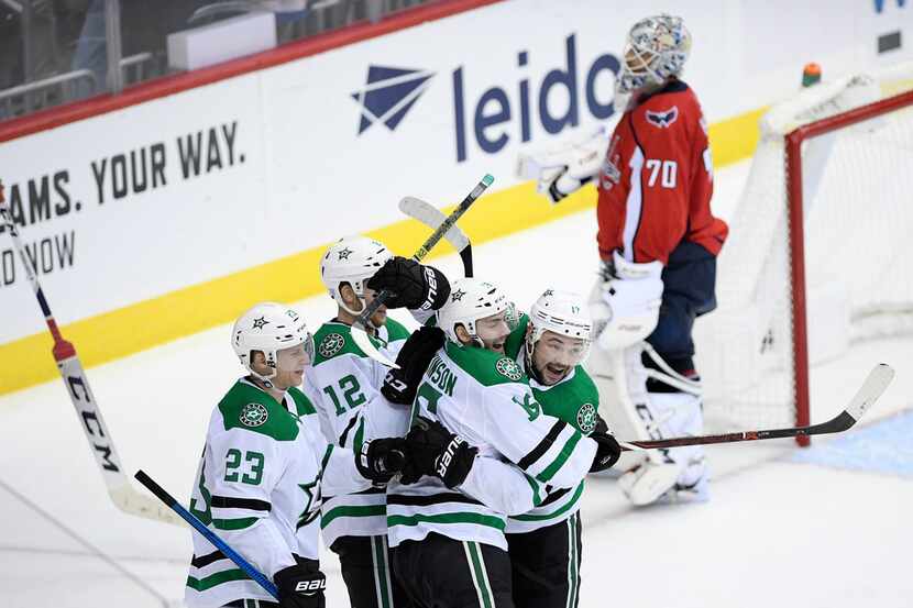 Dallas Stars center Jason Dickinson (16) celebrates his game-winning goal with center Devin...