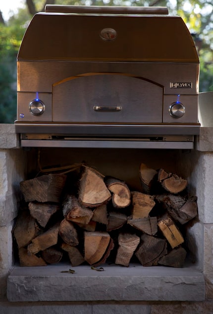 Wood sits under a stove in the outdoor cooking area at chef Kent Rathbun's home.