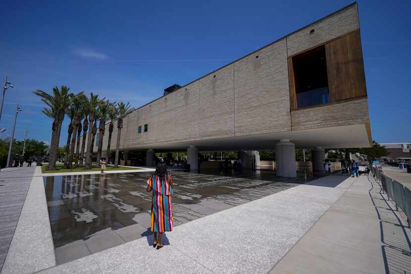 A visitor takes a picture at June's opening of the International African American Museum in...