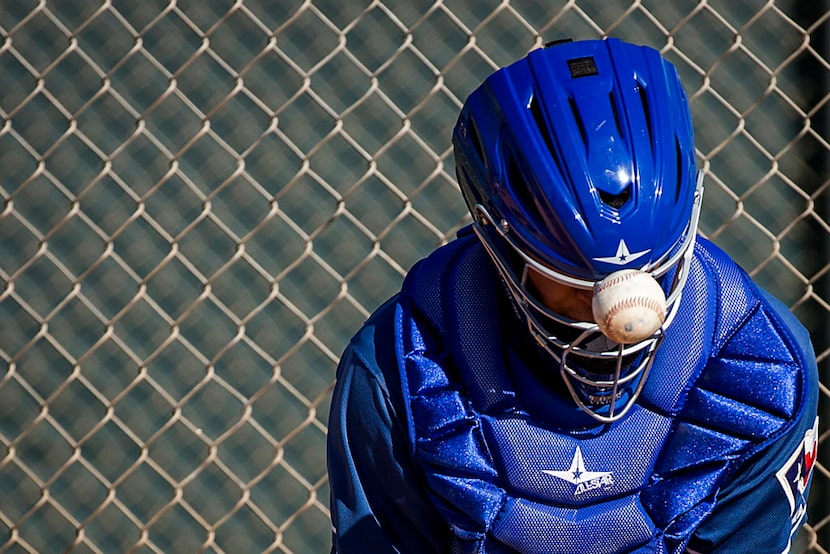 Texas Rangers minor league catcher Jose Trevino has a ball bounce off his mask during a...