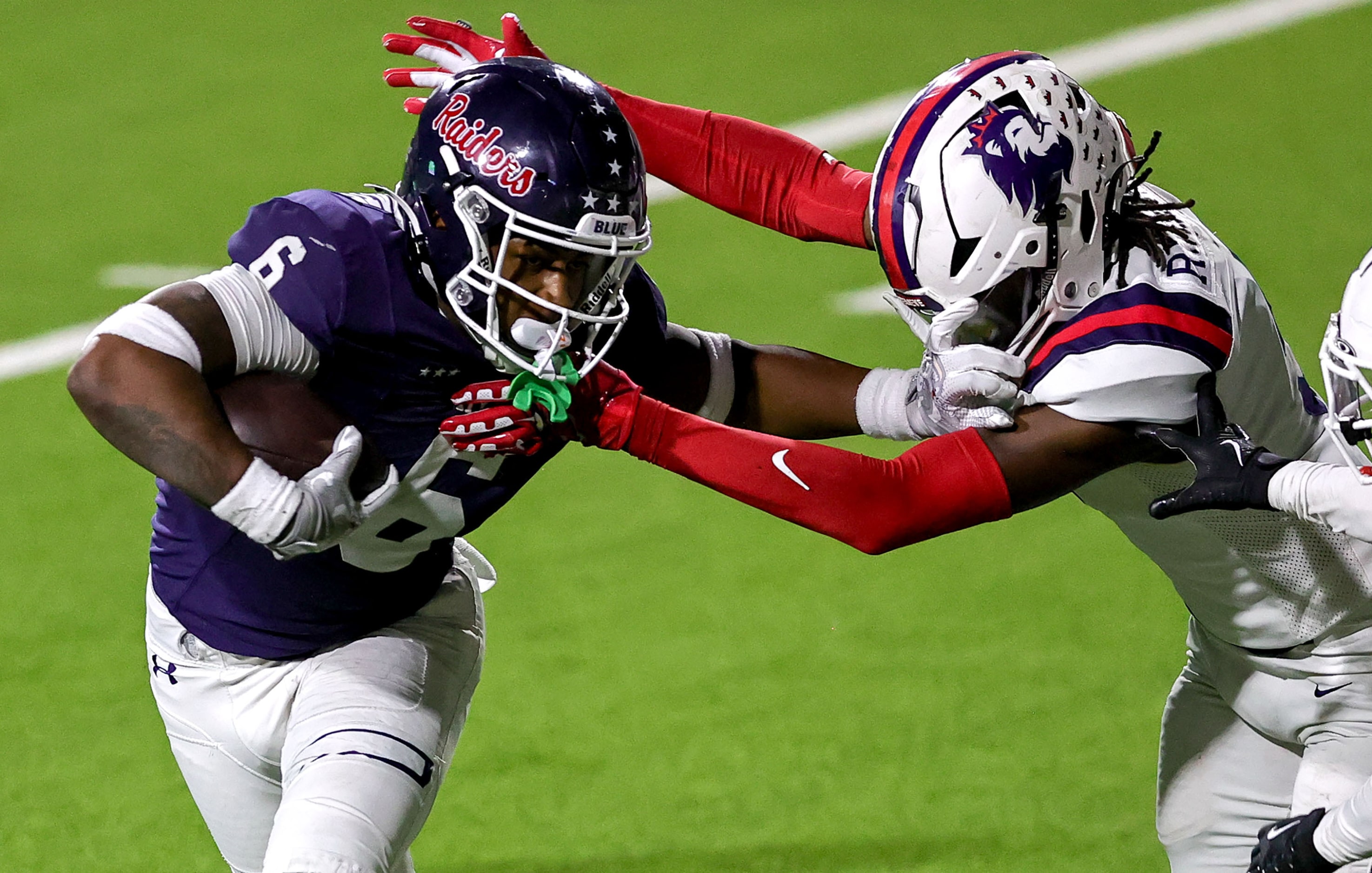 Denton Ryan running back Tre'Vaughn Reynolds (6) gives a stiff arm to Richland linebacker...