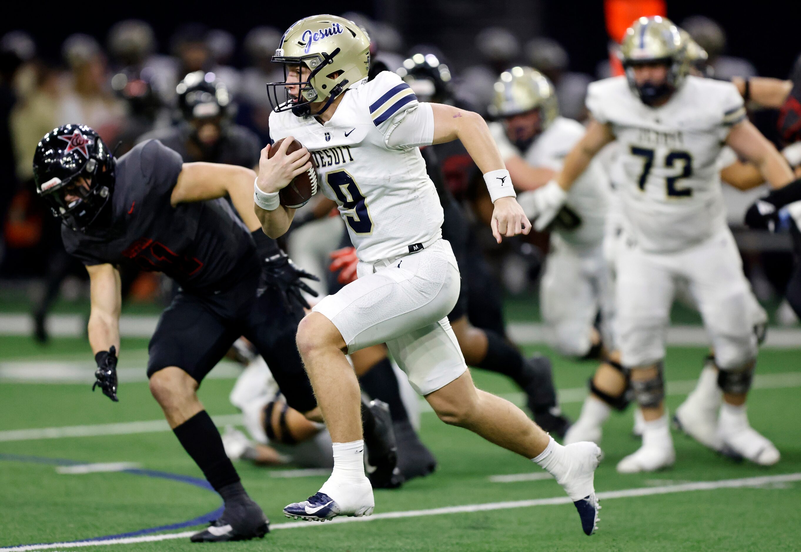 Jesuit quarterback Charlie Peters (9) races around the end against the Coppell defense...