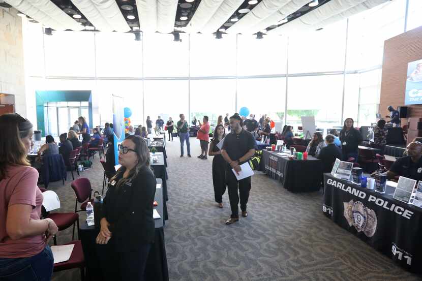 Community members discuss employment opportunities during the city of Garland Career Fair at...