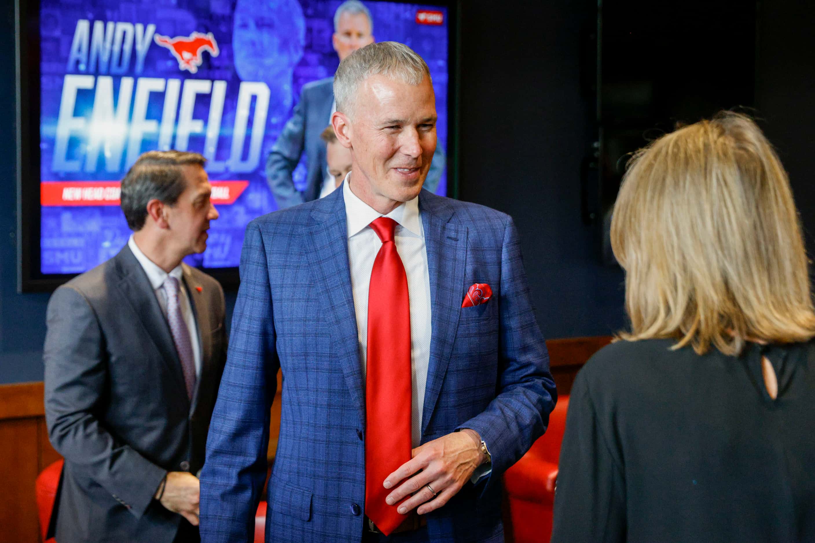 SMU head men's basketball coach Andy Enfield talks with an attendee after an introductory...