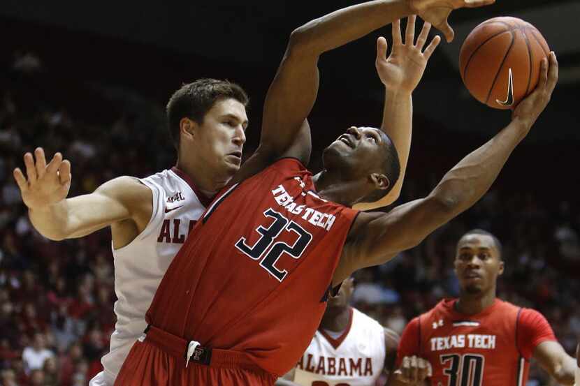 Texas Tech's Jordan Tolbert (32) is fouled by Alabama's Carl Engstrom (4) during the first...