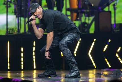 Spanish singer Enrique Iglesias rides a treadmill like device during his opening act for a...