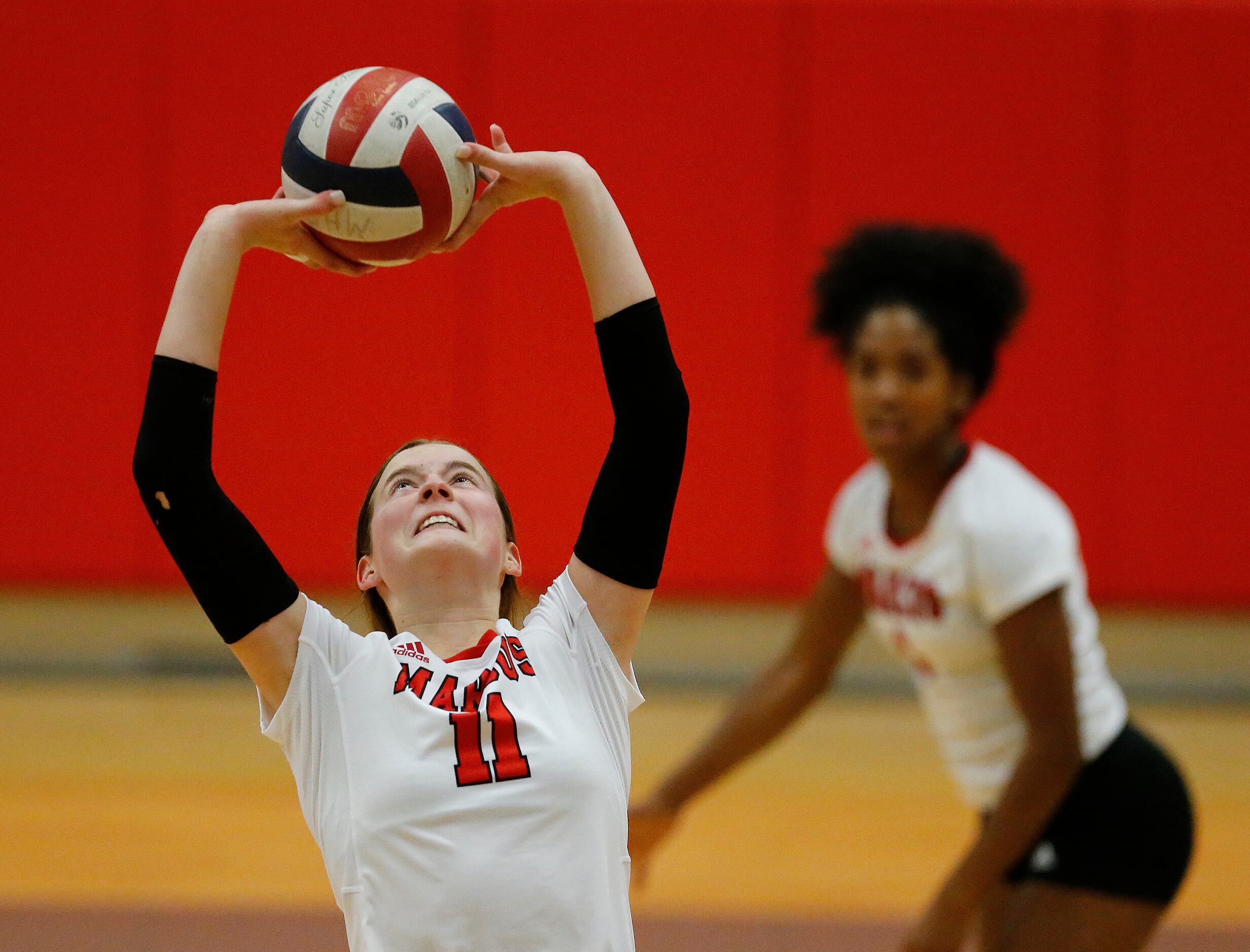 Marcus setter Lexi Godby (11) makes a set in game two as Flower Mound Marcus High School...