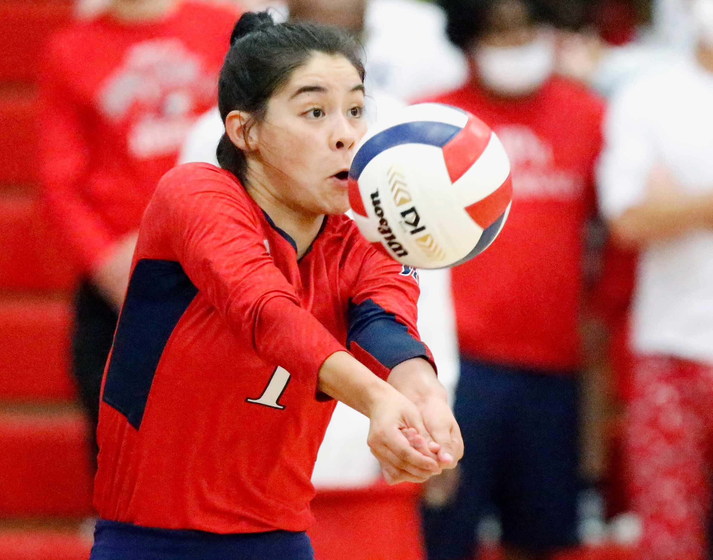 John Paul II High School defensive specialist Nicole Solis (1) receives a serve during game...
