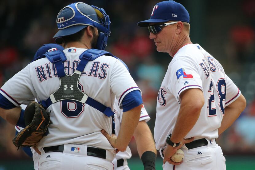 Texas Rangers manager Jeff Banister (28) and catcher Brett Nicholas (6) are pictured during...