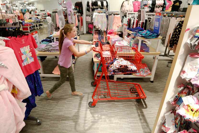 Brianna Foster, 9 of Lucas pushes the cart as she shops with her grandmother, Joni McConnell...