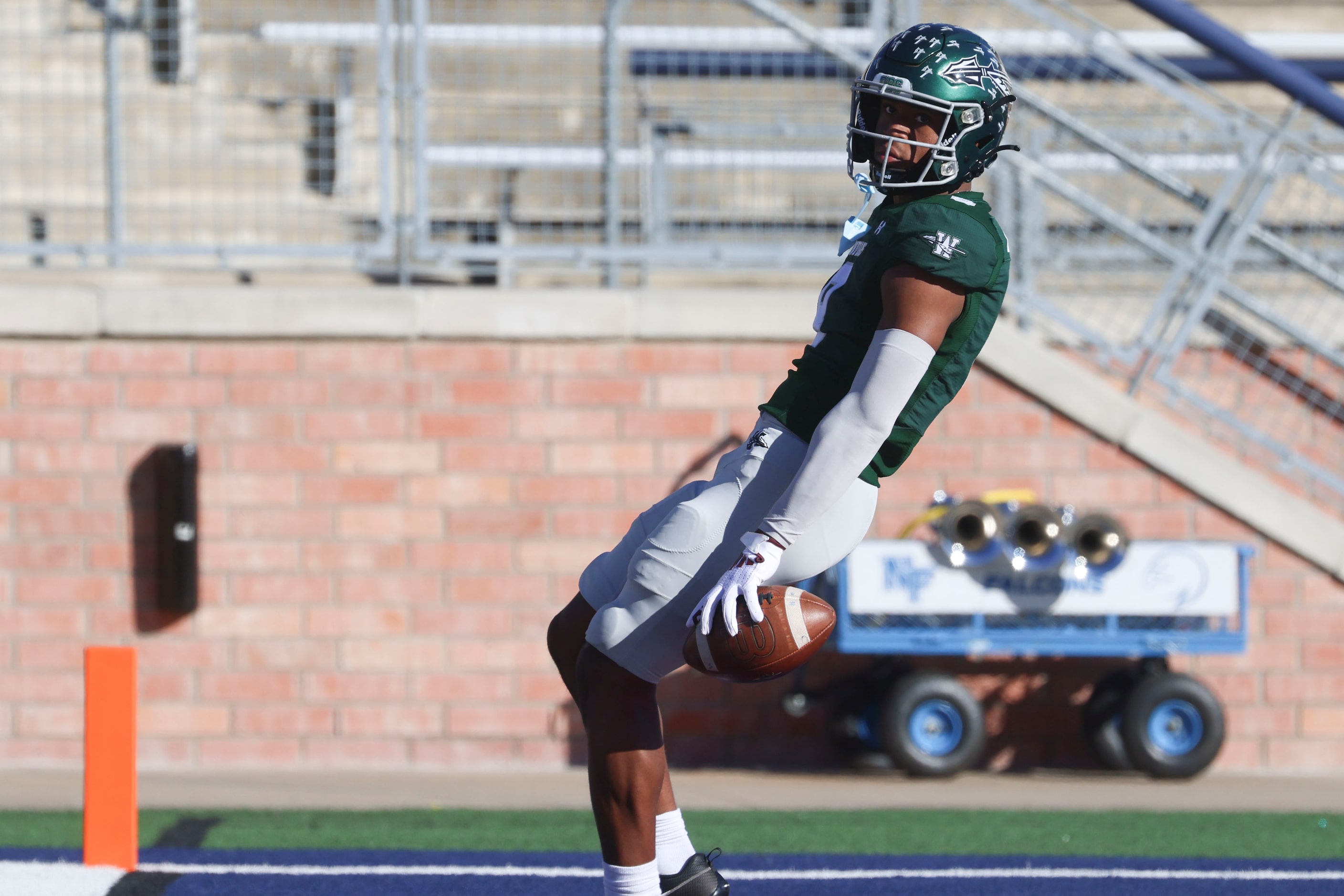 Waxahachie High’s Kohen Brown looks as he scores a 20-yard touchdown against North Forney...