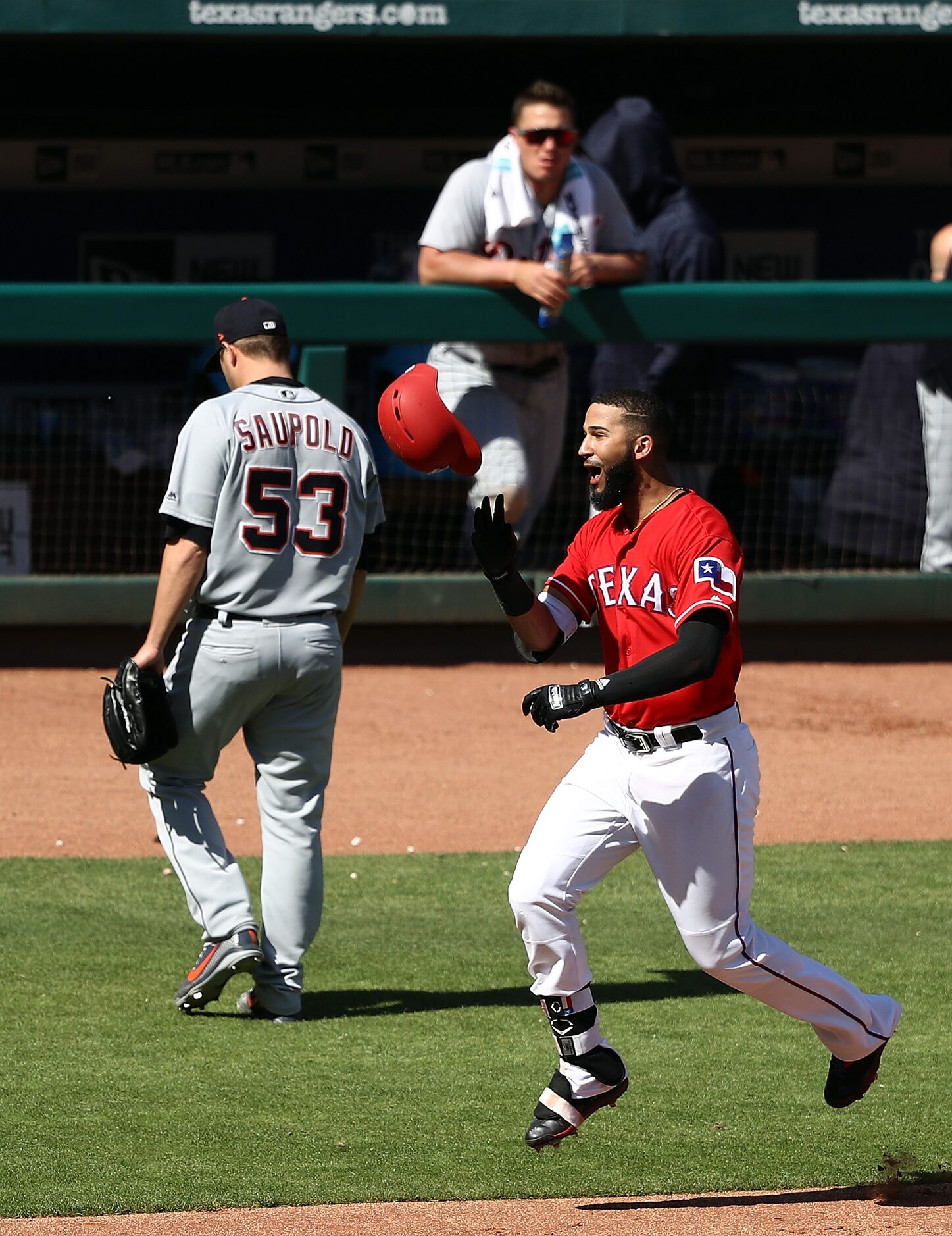 ARLINGTON, TX - MAY 09:  Nomar Mazara #30 of the Texas Rangers runs past Warwick Saupold #53...