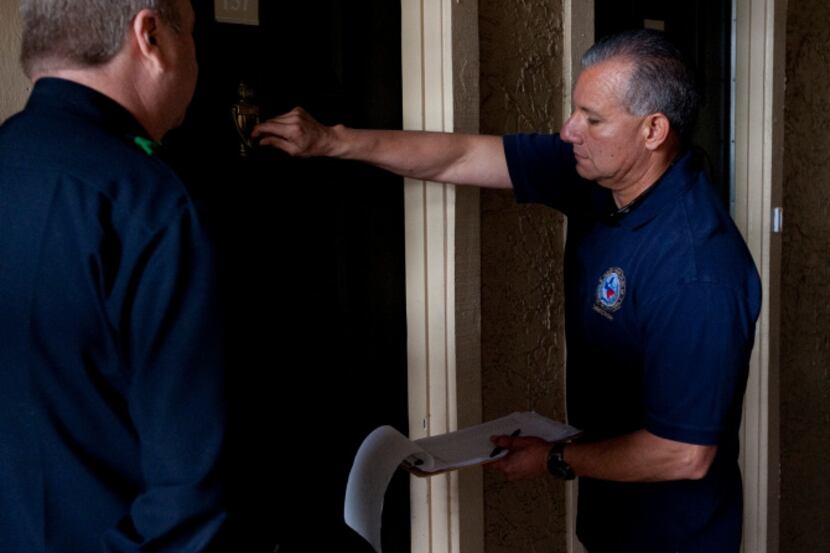 Alan Bull (left) and Raul Moreno of the Dallas Police Department went door-to-door as a part...