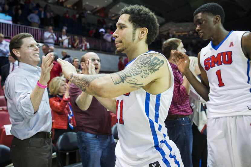 Southern Methodist Mustangs guard Nic Moore (11) and guard Shake Milton (1) high-five fans...