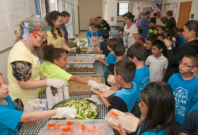 Alex Sanger Elementary School students  line up for organically grown food from the Promise...