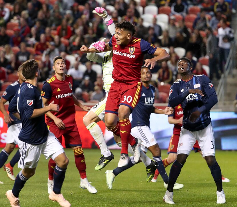 New England Revolution goalkeeper Brad Knighton (18) knocks the ball away form Real Salt...