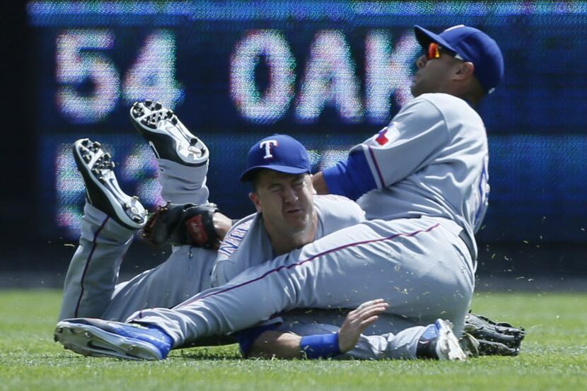 Texas Rangers center fielder Dan Robertson missed on a diving attempt to catch a fly ball by...