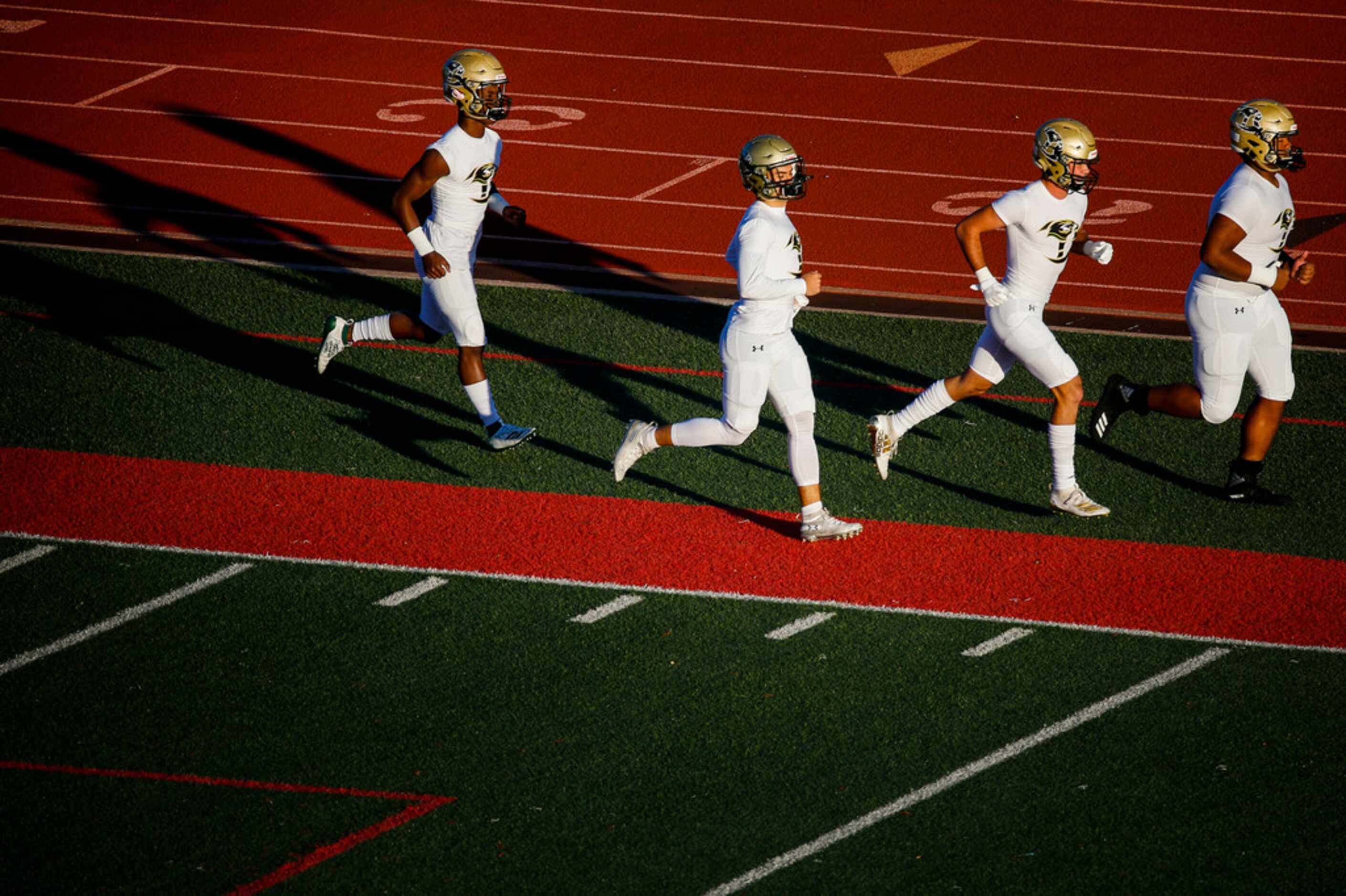 Birdville players warm up prior to a high school football game between Colleyville Heritage...