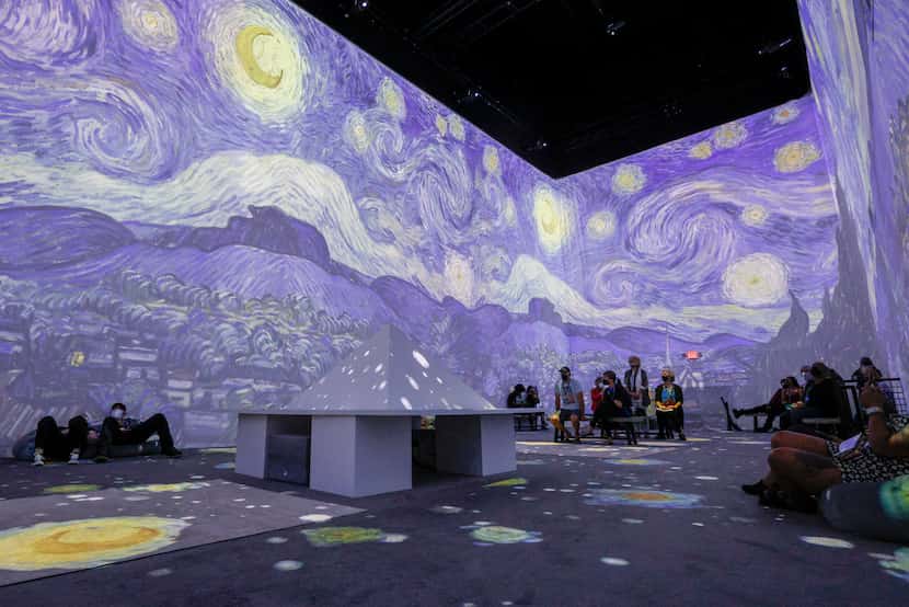 Visitors watch projections of work by Vincent Van Gogh at Van Gogh: The Immersive Experience...