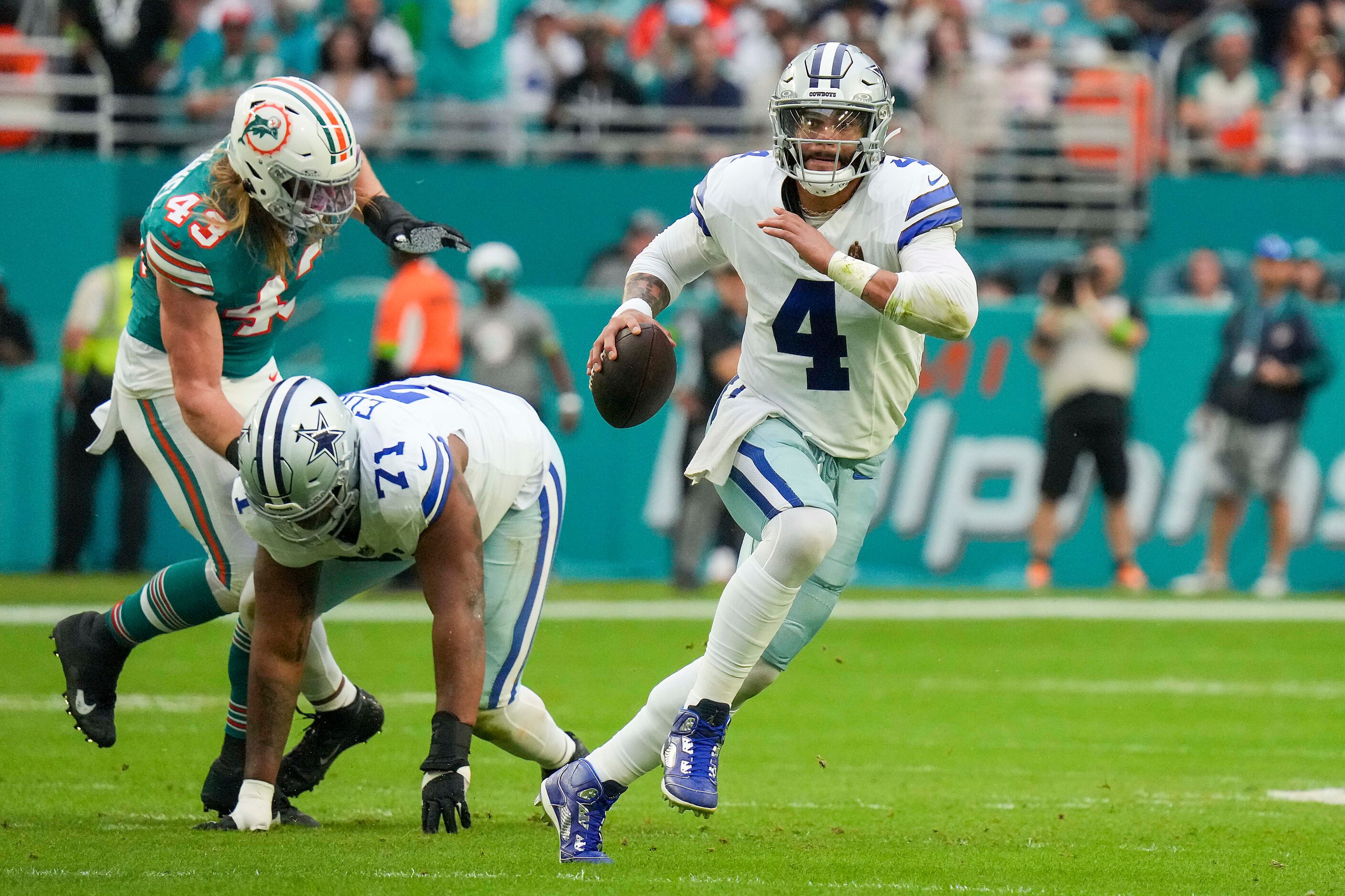 Dallas Cowboys quarterback Dak Prescott (4) scrambles away from Miami Dolphins linebacker...