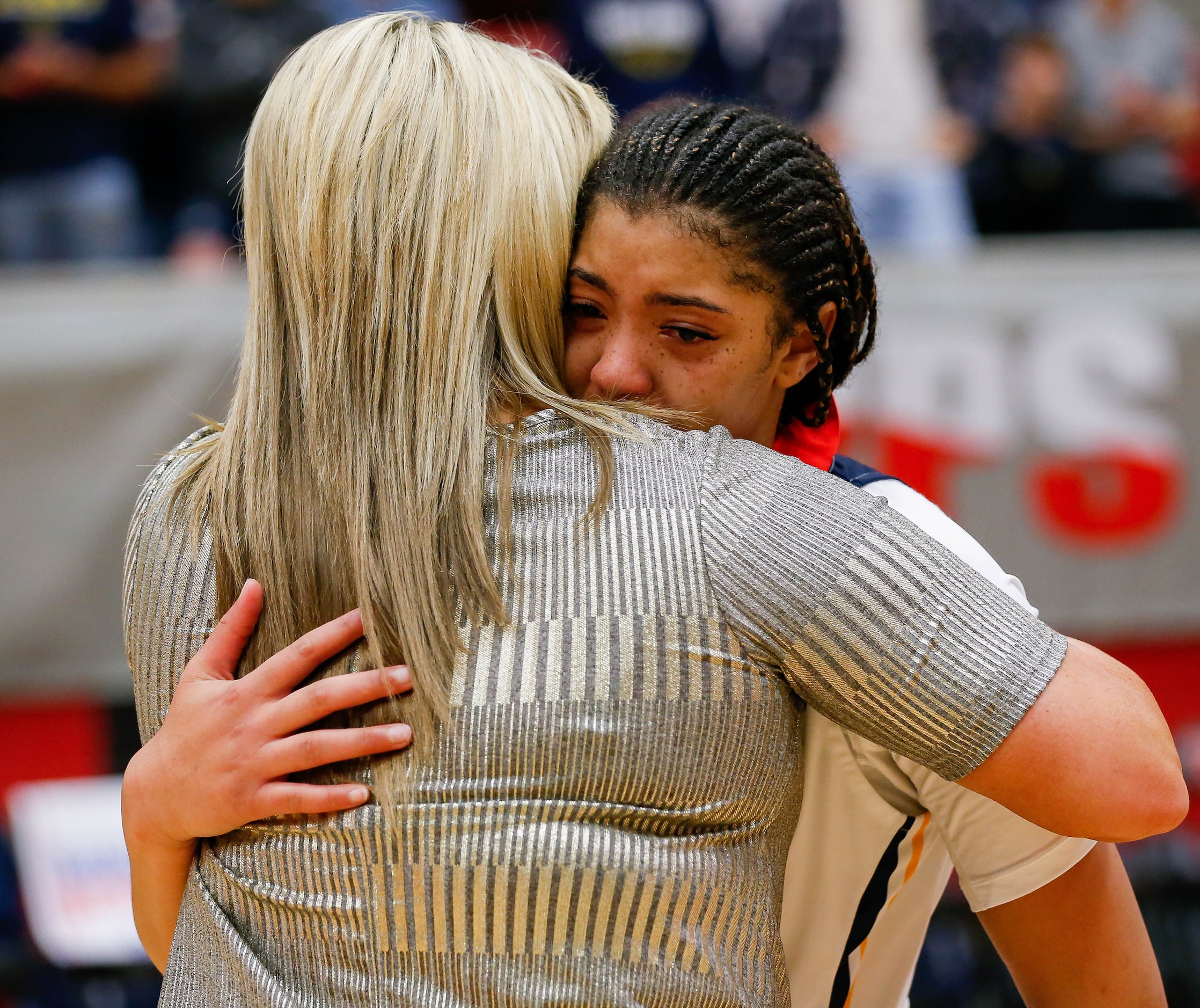 Plano Prestonwood Christian's Jordan Webster (32) hugs coach Holly Mulligan after losing a...