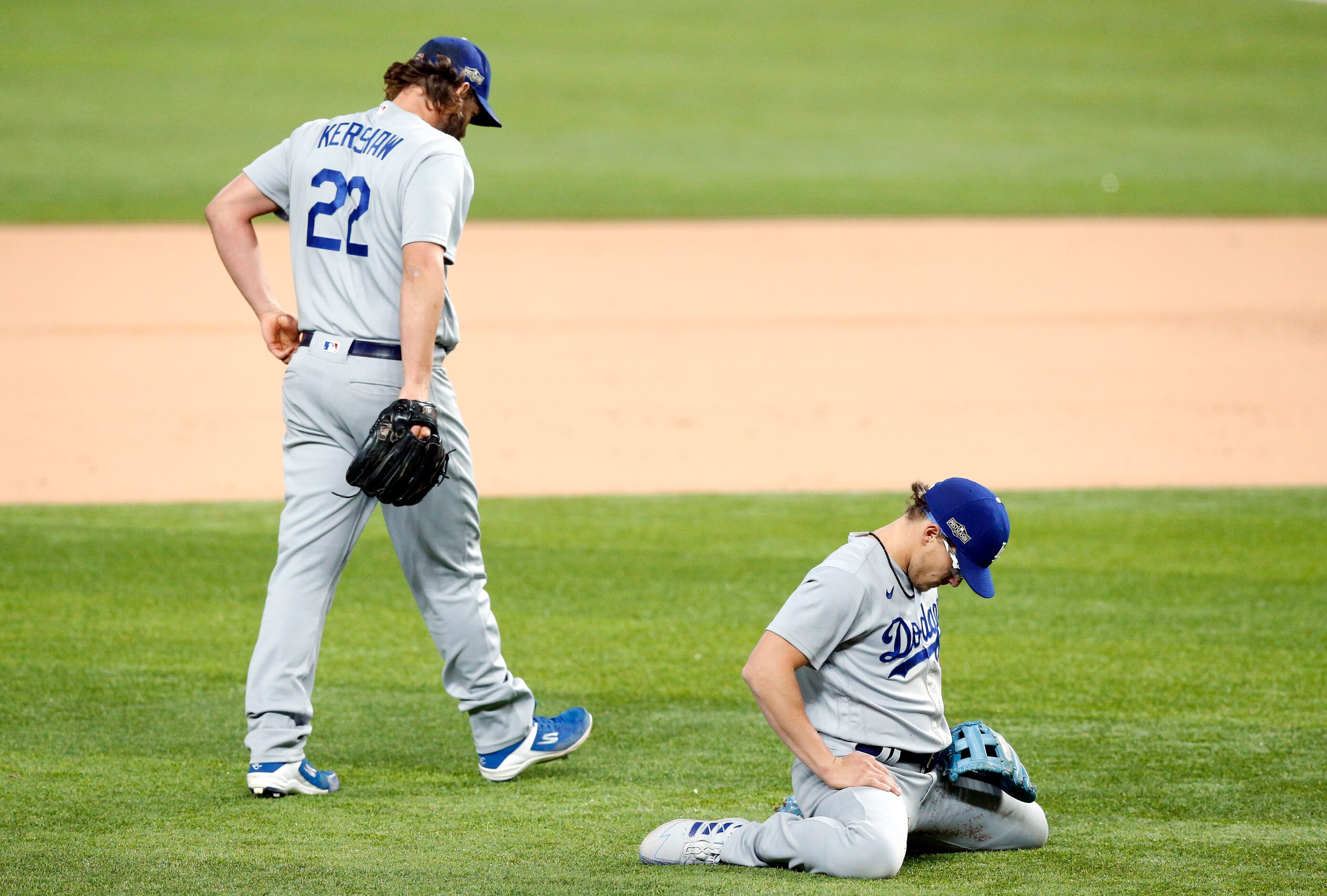 Los Angeles Dodgers second baseman Enrique Hernandez (14) drops to his knees after his throw...