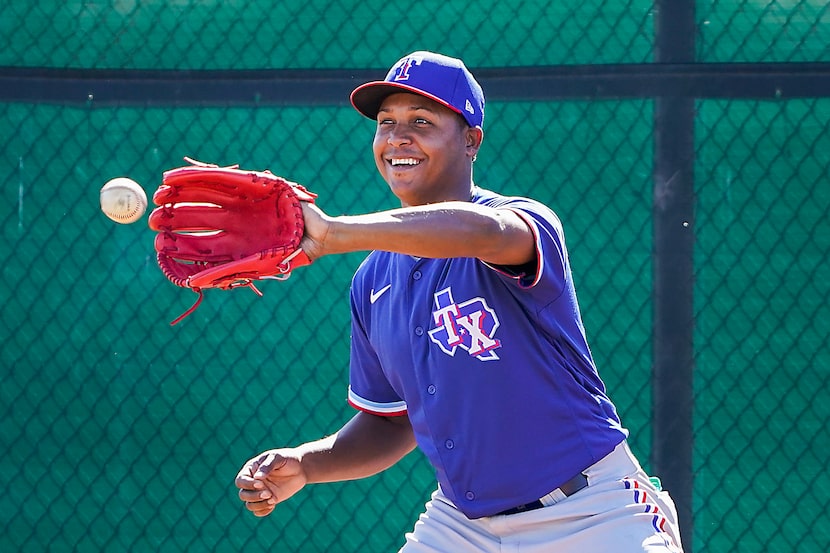 Texas Rangers pitcher Jose Leclerc participates in a fielding drill during a spring training...