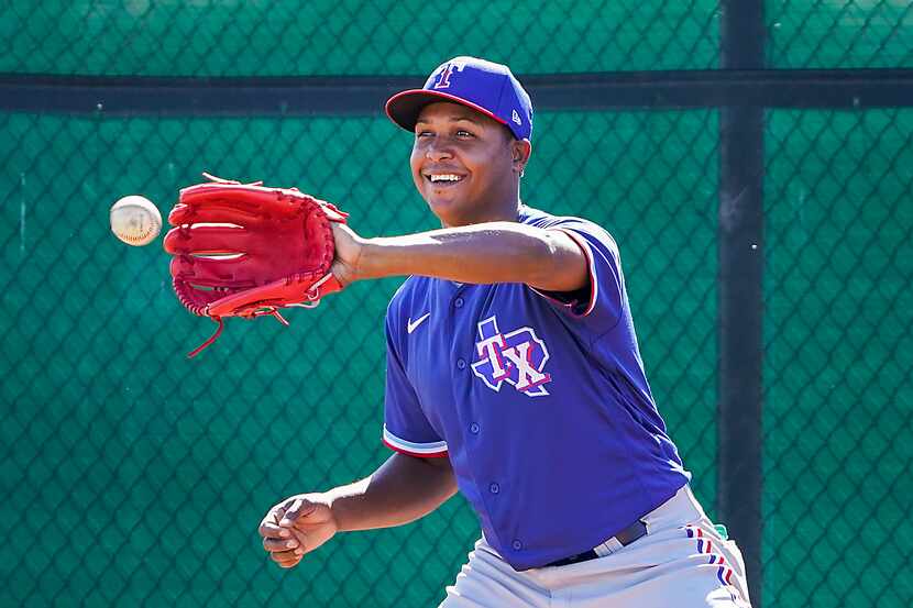 Texas Rangers pitcher Jose Leclerc participates in a fielding drill during a spring training...