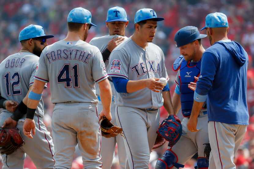 Texas Rangers starting pitcher Ariel Jurado, center right, is relieved by manager Chris...
