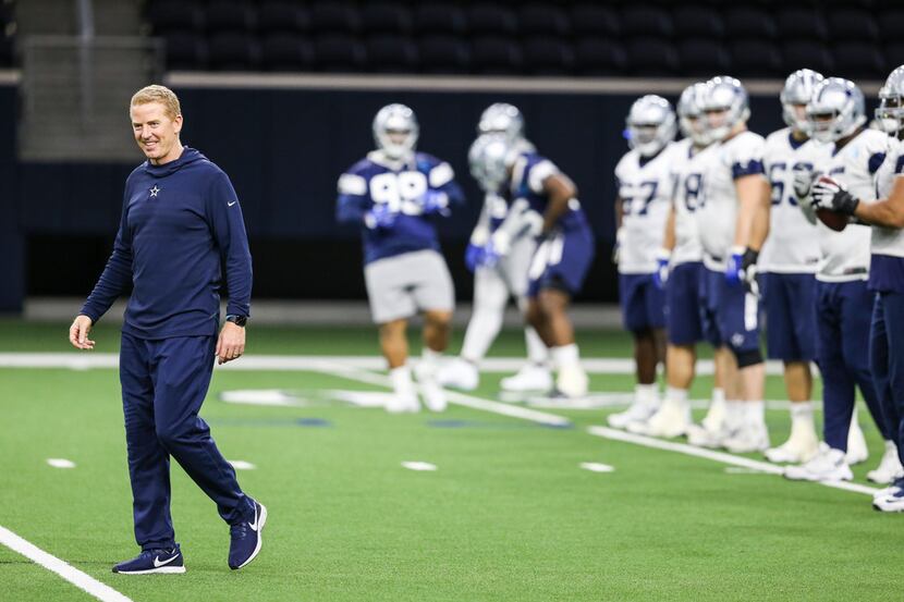 Dallas Cowboys head coach Jason Garrett warms up with the team during a Cowboys practice...