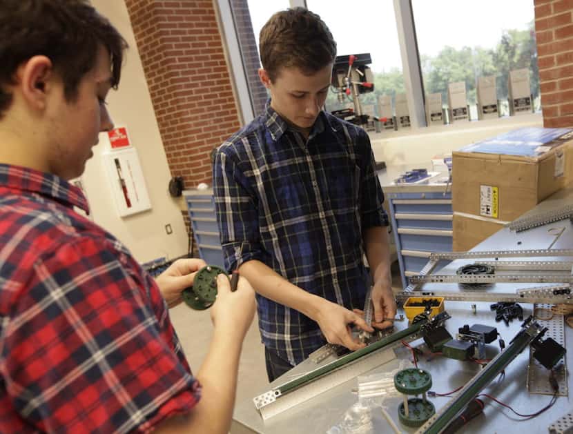 Tyler Gassman (left) and Connor Redding work on a project in a robotics class at Lovejoy...