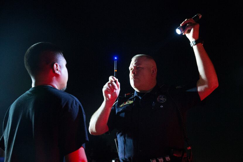 Officer Stephen Burres III gives a field sobriety test during DWI stop in Irving. 