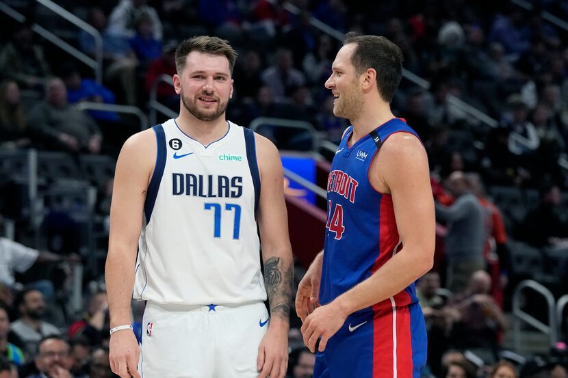 Dallas Mavericks guard Luka Doncic (77) talks with Detroit Pistons forward Bojan Bogdanovic...