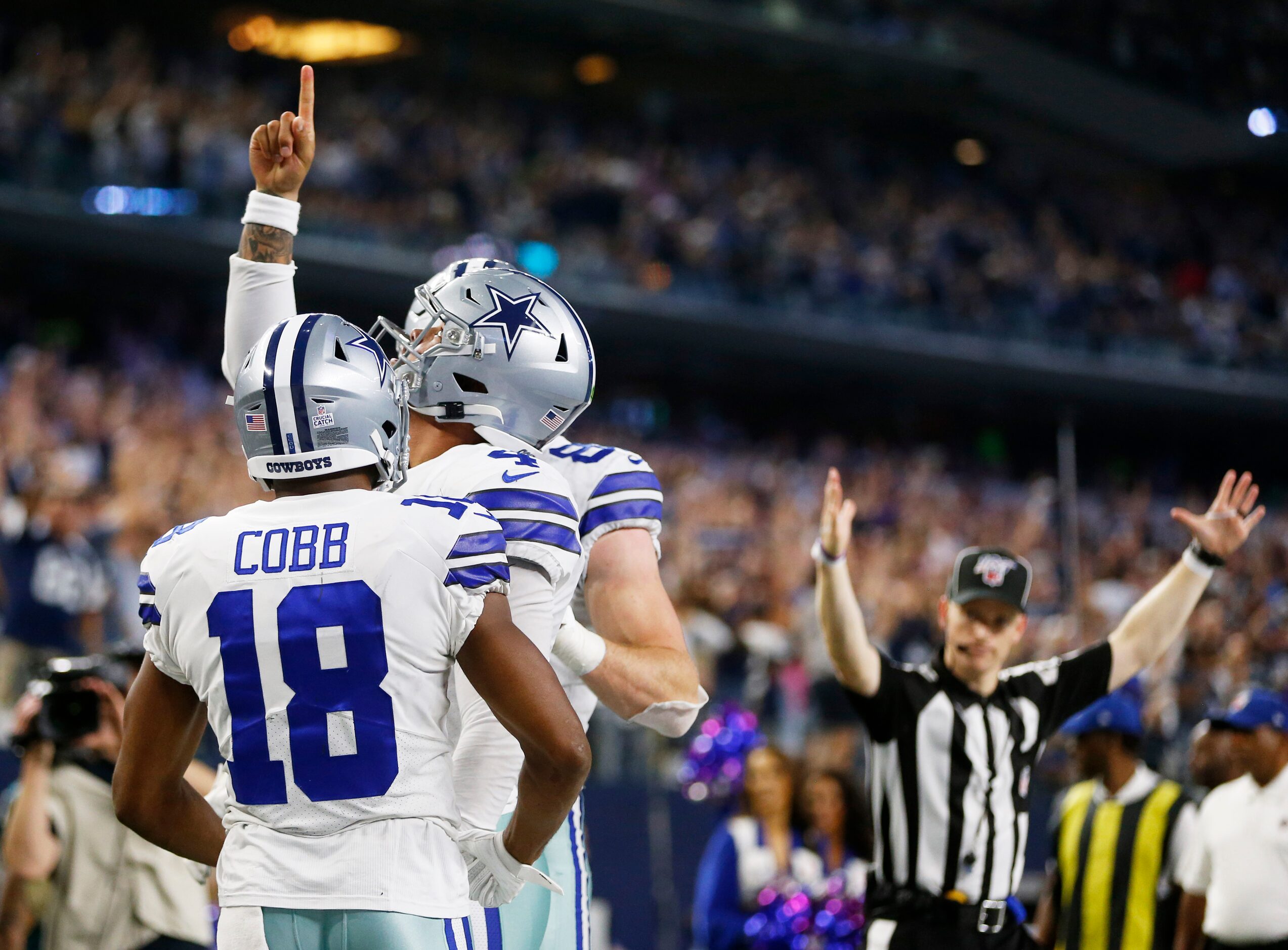 Dallas Cowboys quarterback Dak Prescott (4) celebrates after scoring a touchdown with...