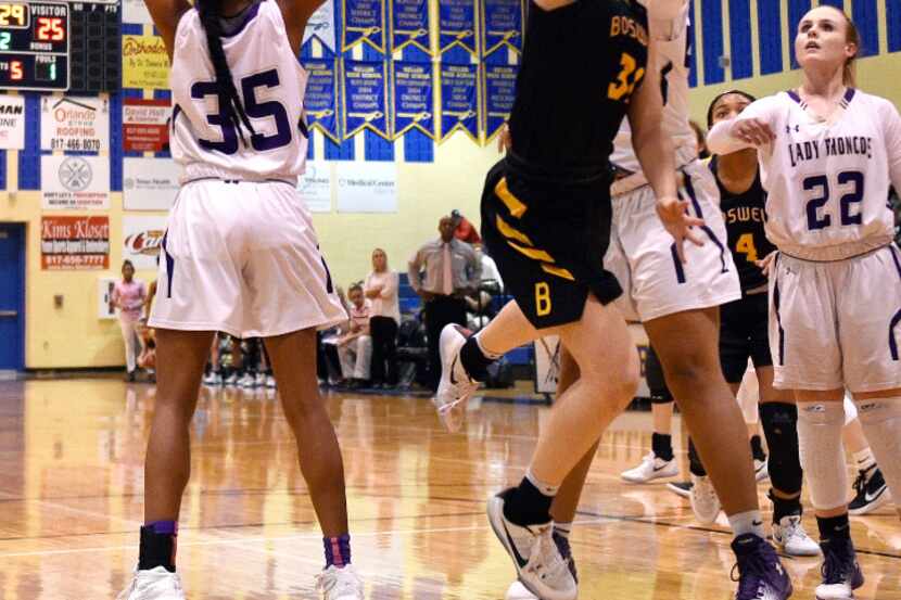 Fort Worth Boswell's Audrey Warren (31) attempts a layup as Denton's Jamie Means (35) and...