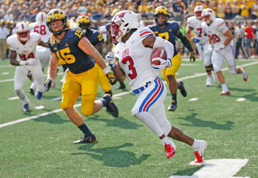 Southern Methodist Mustangs wide receiver James Proche (3) motors for yardage as Michigan...