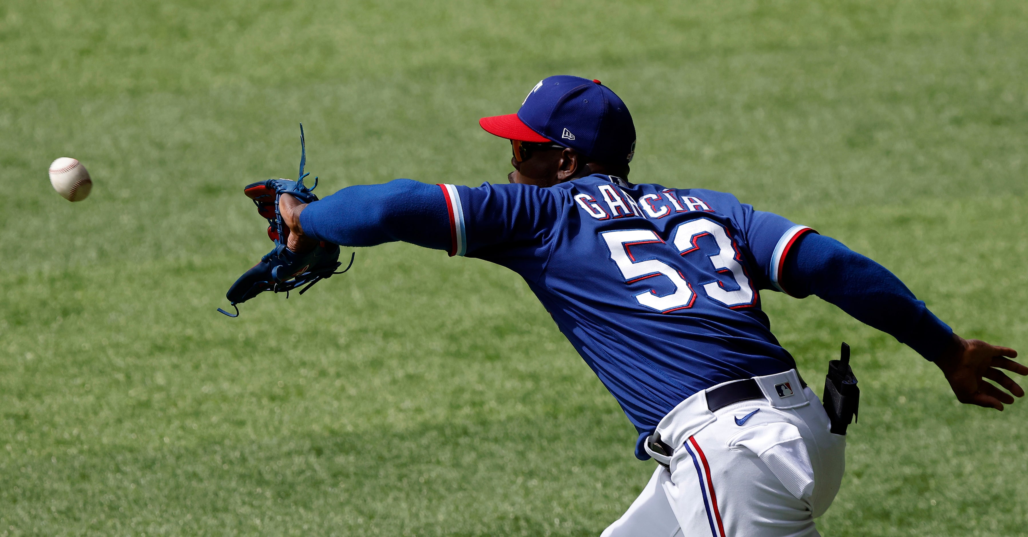 Texas Rangers right fielder Adolis García snares a line drive by Milwaukee Brewers batter...