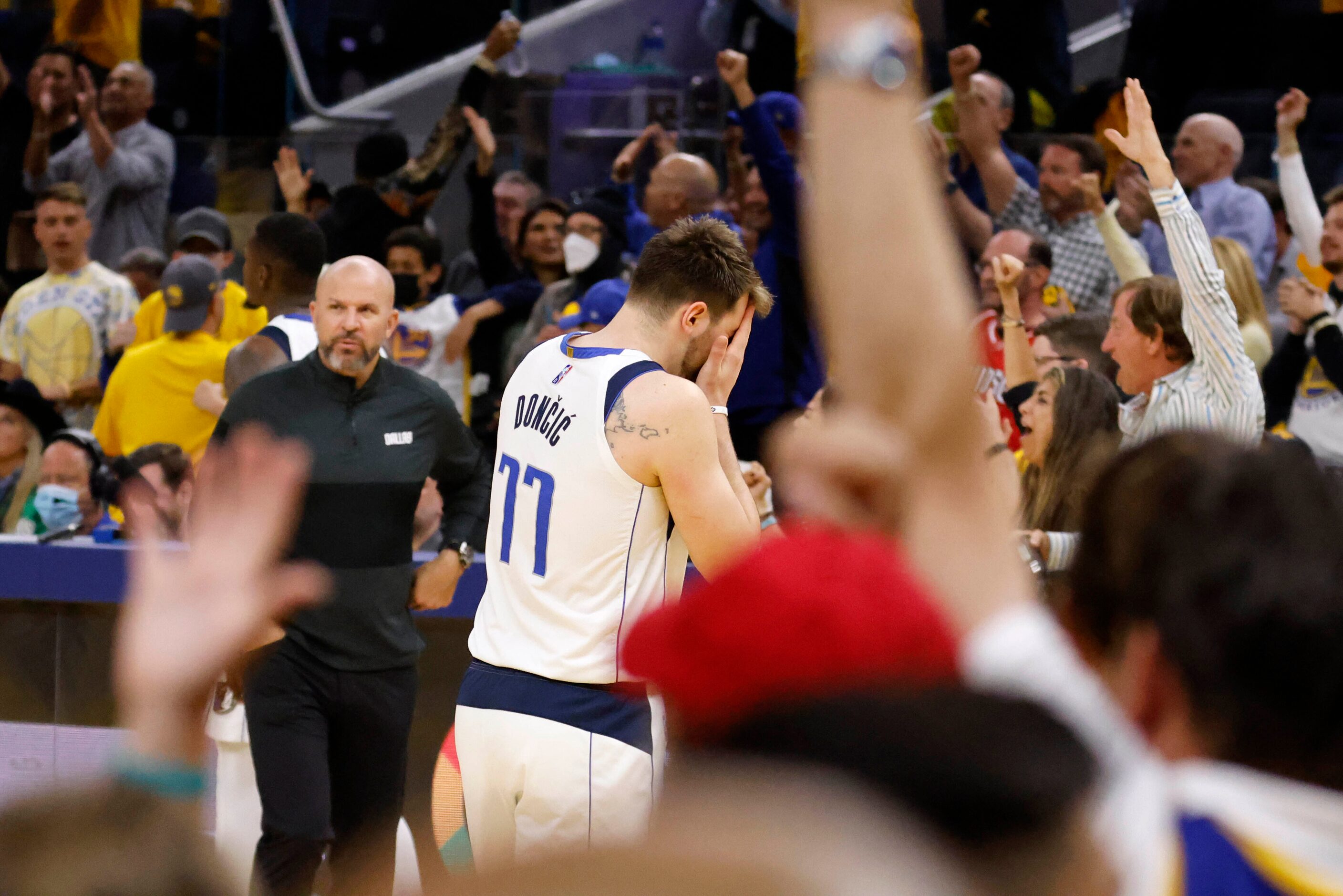 Dallas Mavericks guard Luka Doncic (77) makes his way towards the bench after a timeout was...