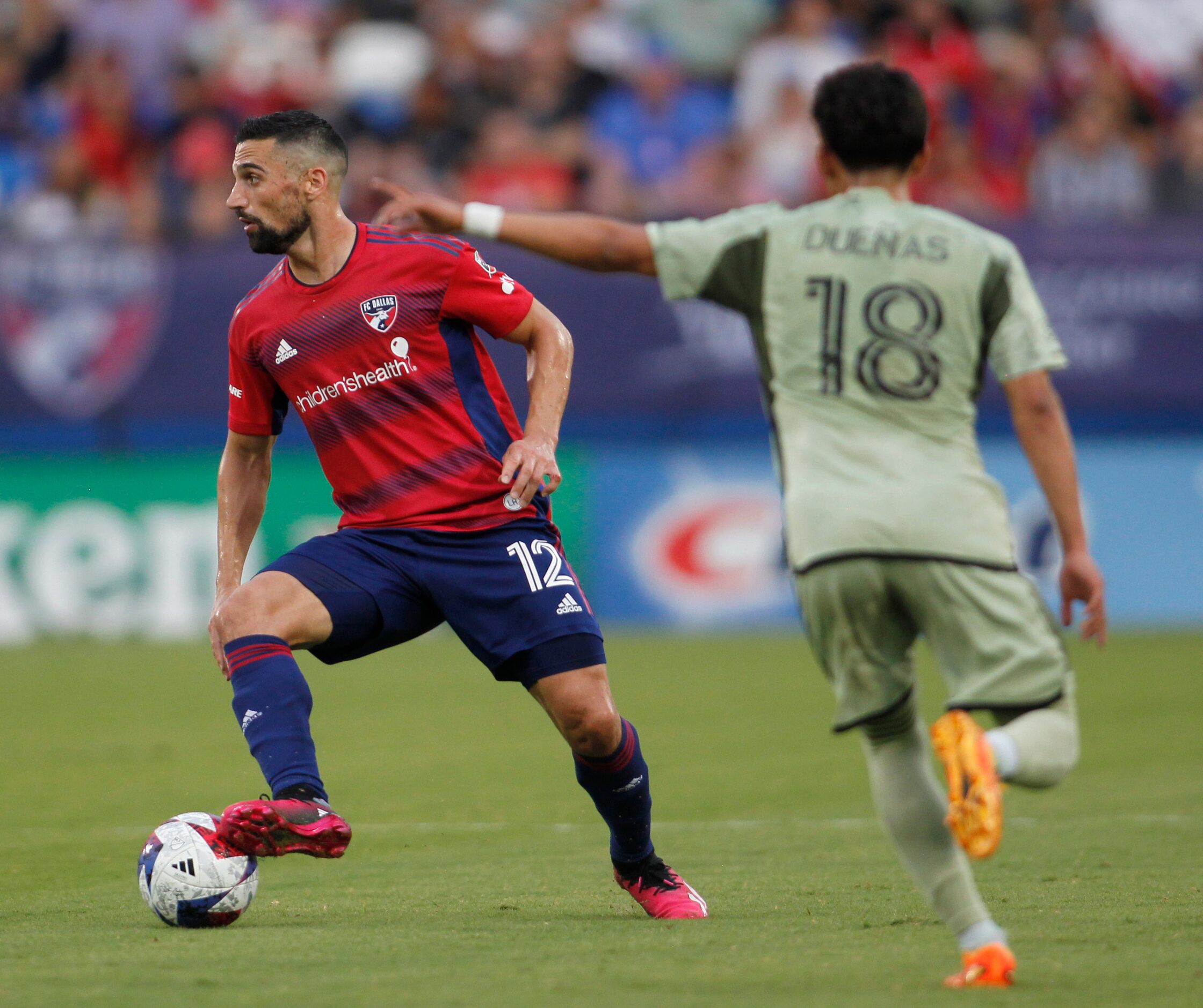 FC Dallas midfielder Sebastian Lietget (12) looks to make a pass as LA Fc defender Erik...