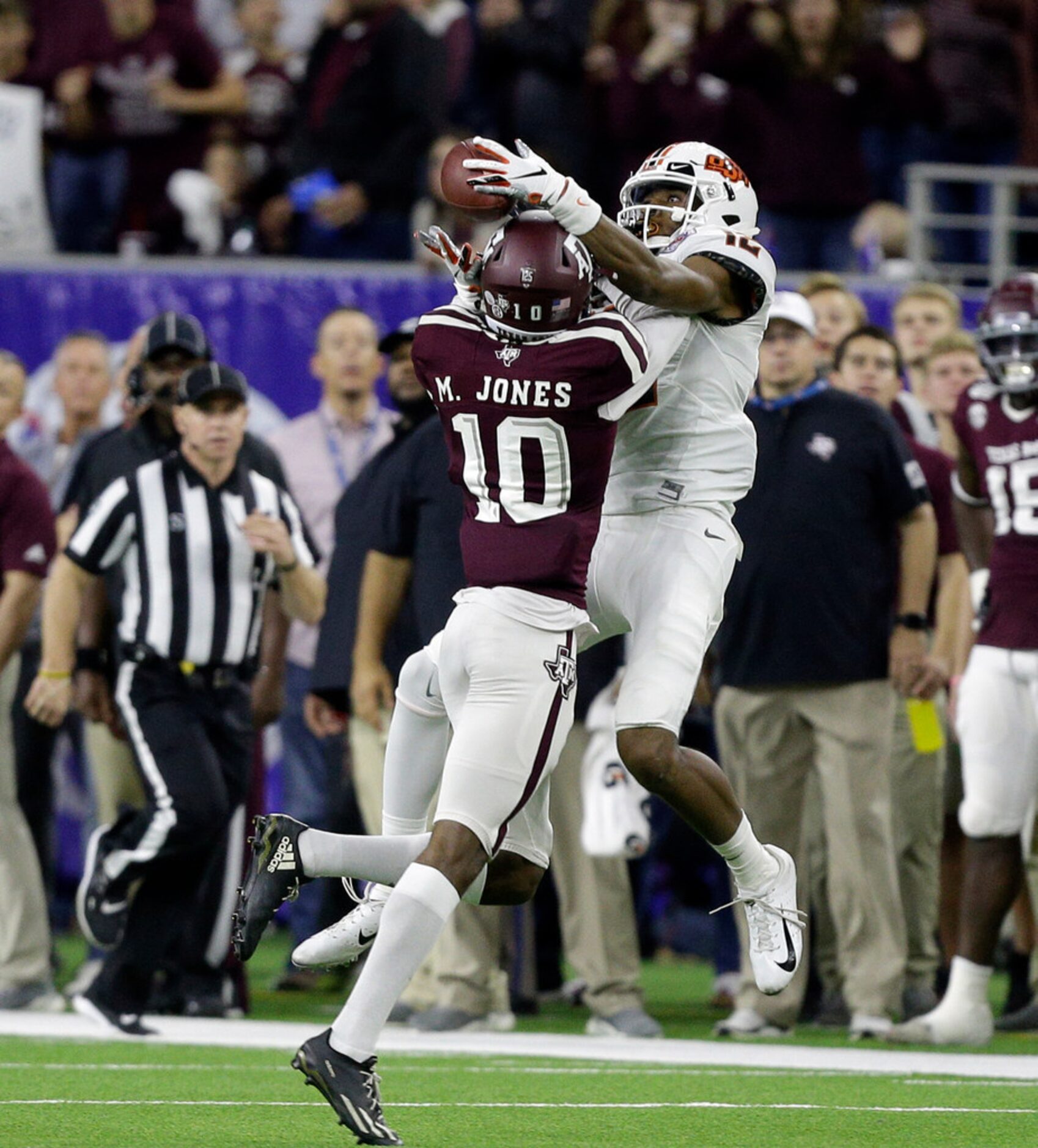 HOUSTON, TEXAS - DECEMBER 27: Myles Jones #10 of the Texas A&M Aggies breaks up a pass...