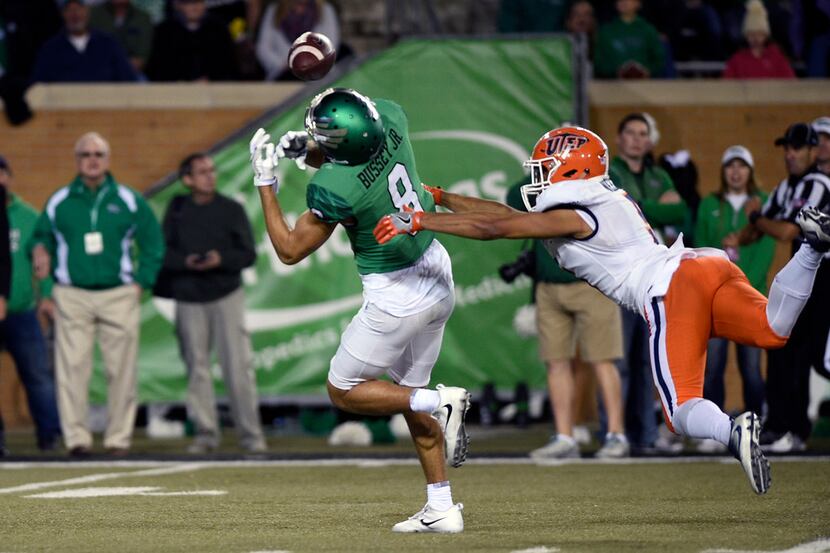 North Texas wide receiver Rico Bussey Jr. (8) receives a pass during an NCAA college...