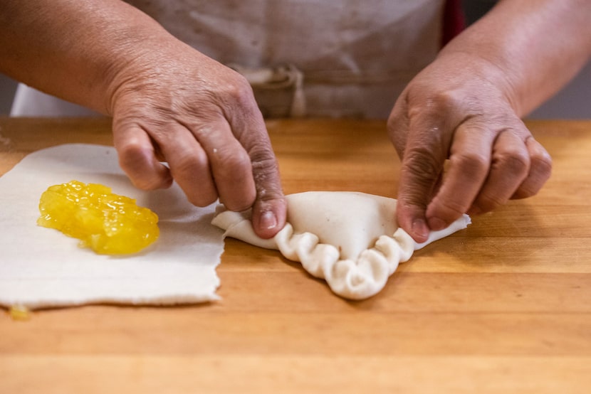 Lupita Arrona makes pineapple empanada at Vera's Bakery Inc. in Dallas on Nov. 13, 2018.