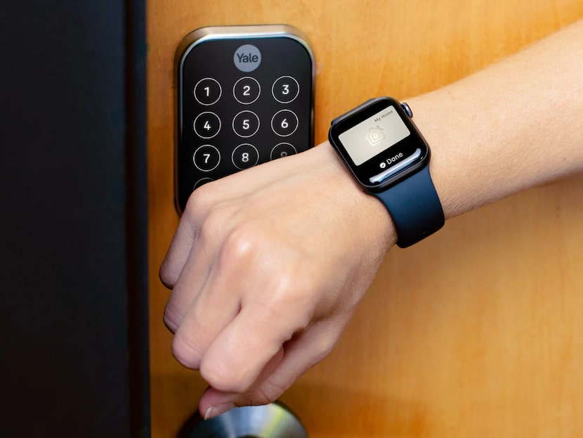 Smart door lock being opened by an Apple Watch