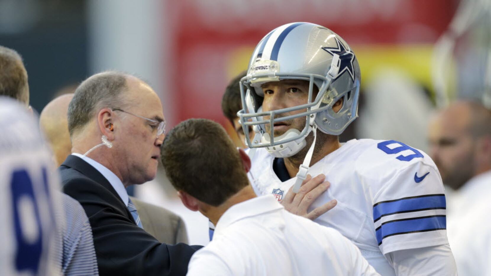 Dallas Cowboys quarterback Tony Romo is examined on the sideline after he left the game with...