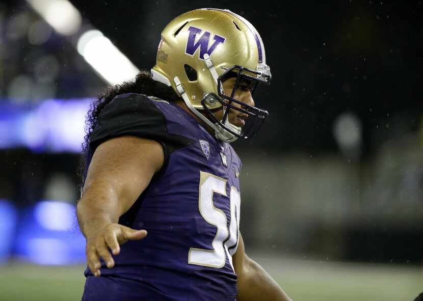 FILE - Washington defensive lineman Vita Vea, stands on the field during an NCAA college...