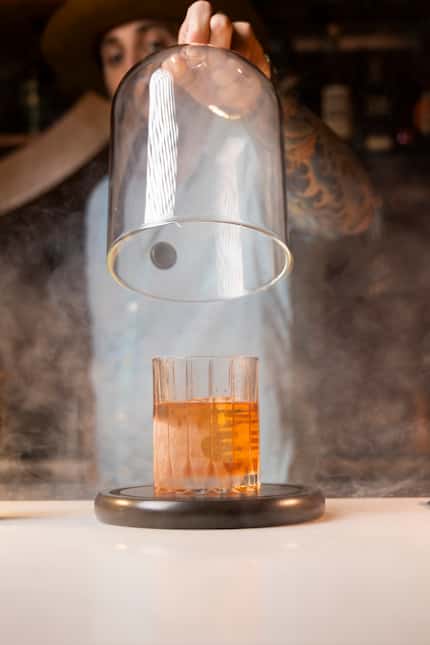 Owner Ryan Oruch prepares The Hot Box cocktail at The Wilfred in Plano.