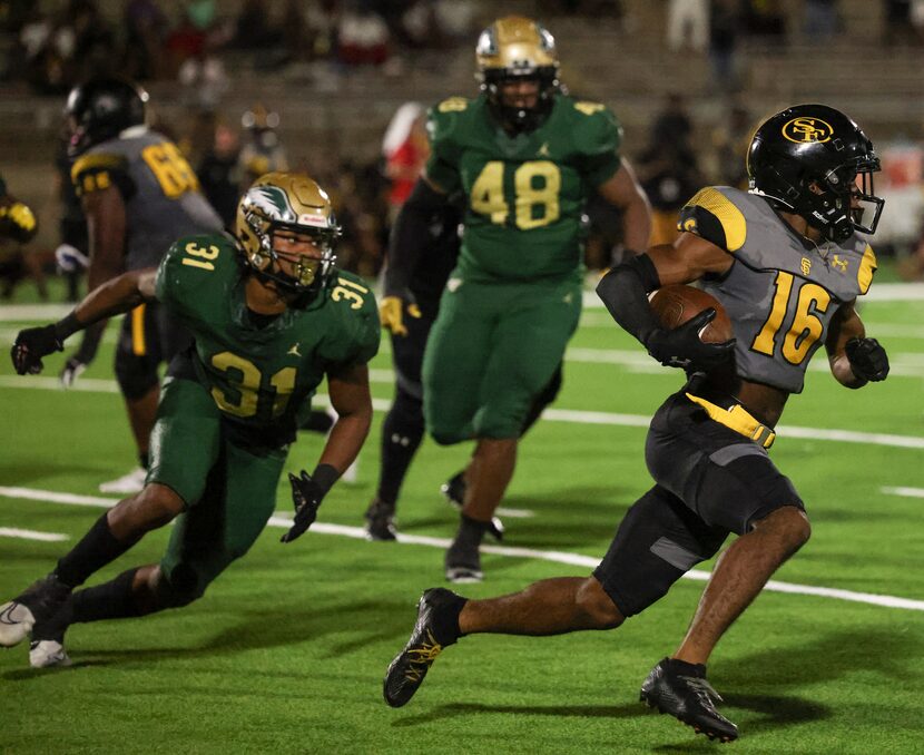 St. Frances Academy Mekhi Workman (16) runs the ball up the field as DeSoto High School...