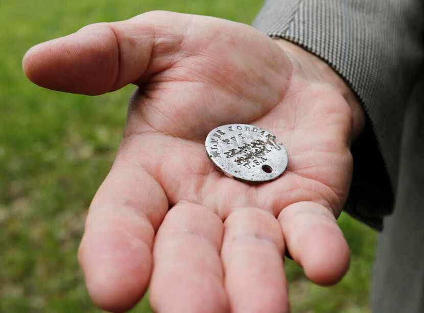 
Bill Jordan of Kaufman holds the World War I dog tag of his grandfather Elmer Jordan.
