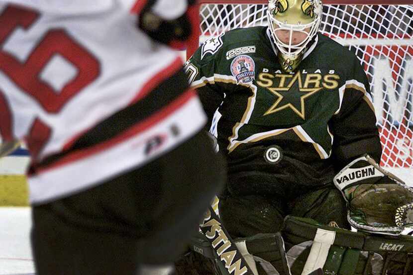  June 1, 2000--Dallas Stars goalie Eddie Belfour uses his body to block a shot by New Jersey...
