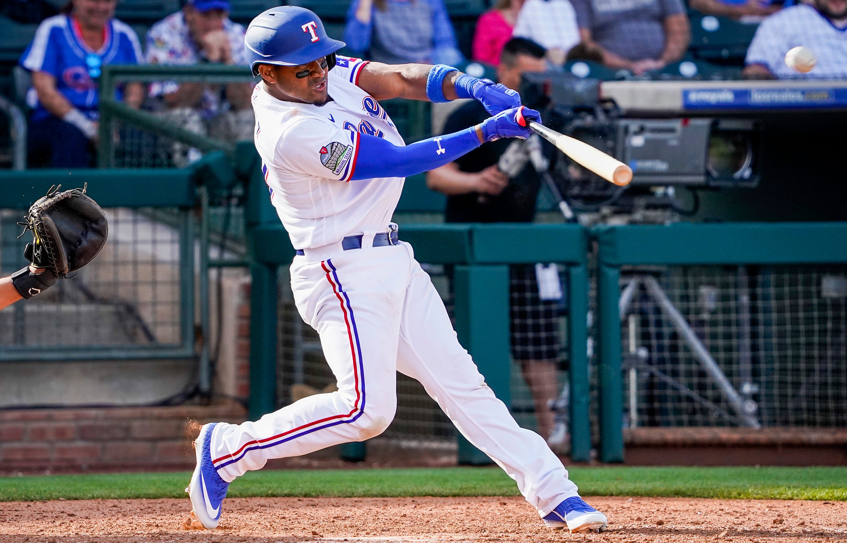 Texas Rangers infielder Andy Ibanez hits a 3-run home run during the eighth inning of a...